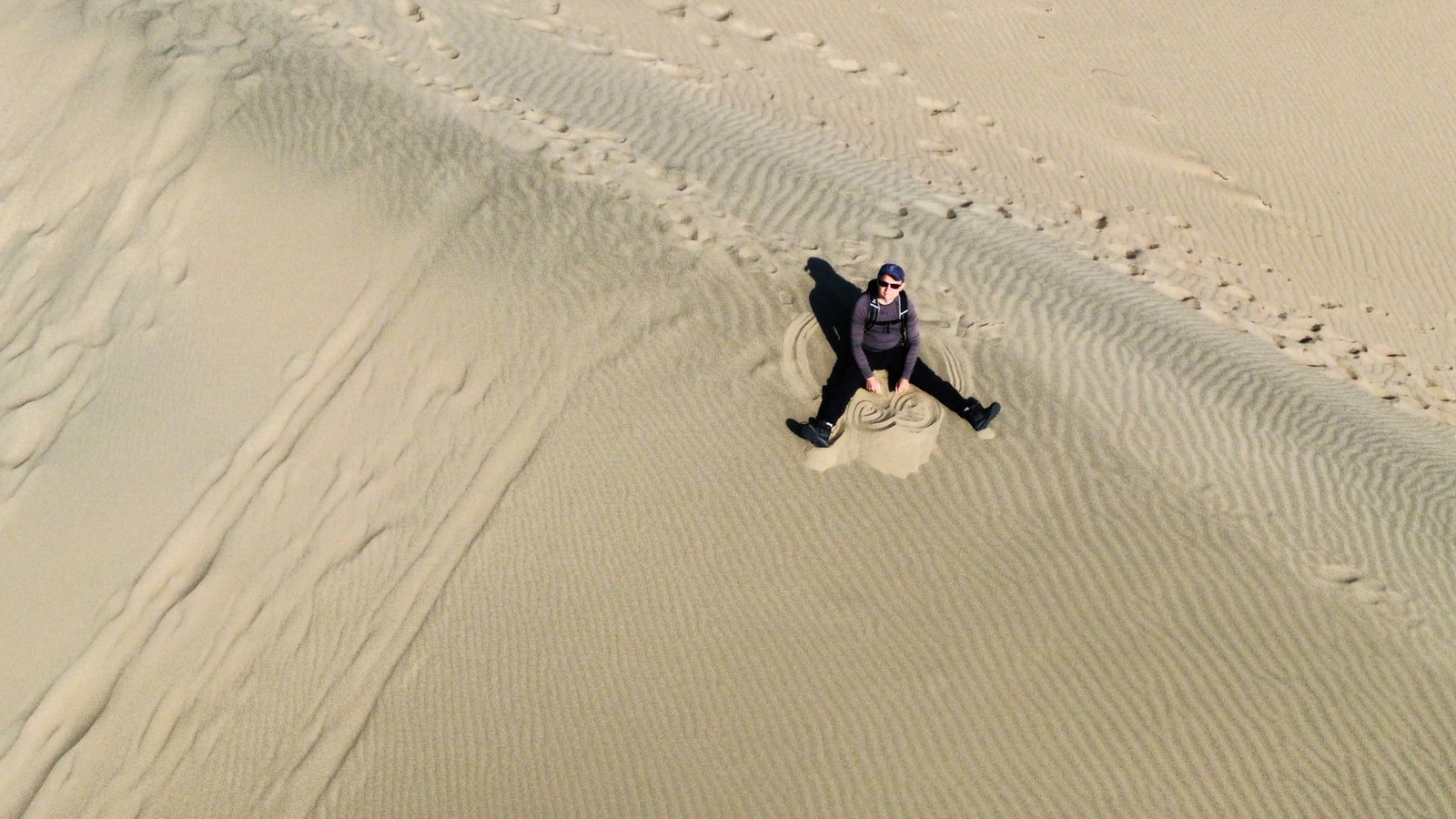 Aerial view of guide sitting on the Singing Dune face — Altyn-Emel National Park