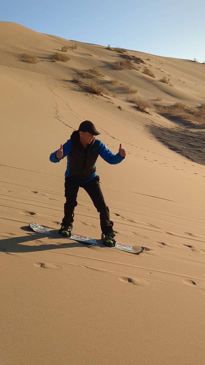 Guest sandboarding on the Singing Dune — Altyn-Emel National Park, Almaty day tour