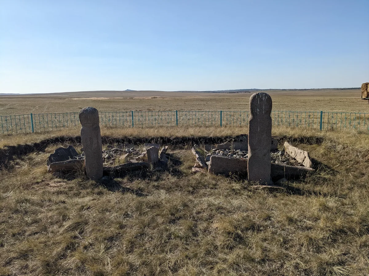 Ancient balbal stone figures on the open Kazakhstan steppe under wide blue sky