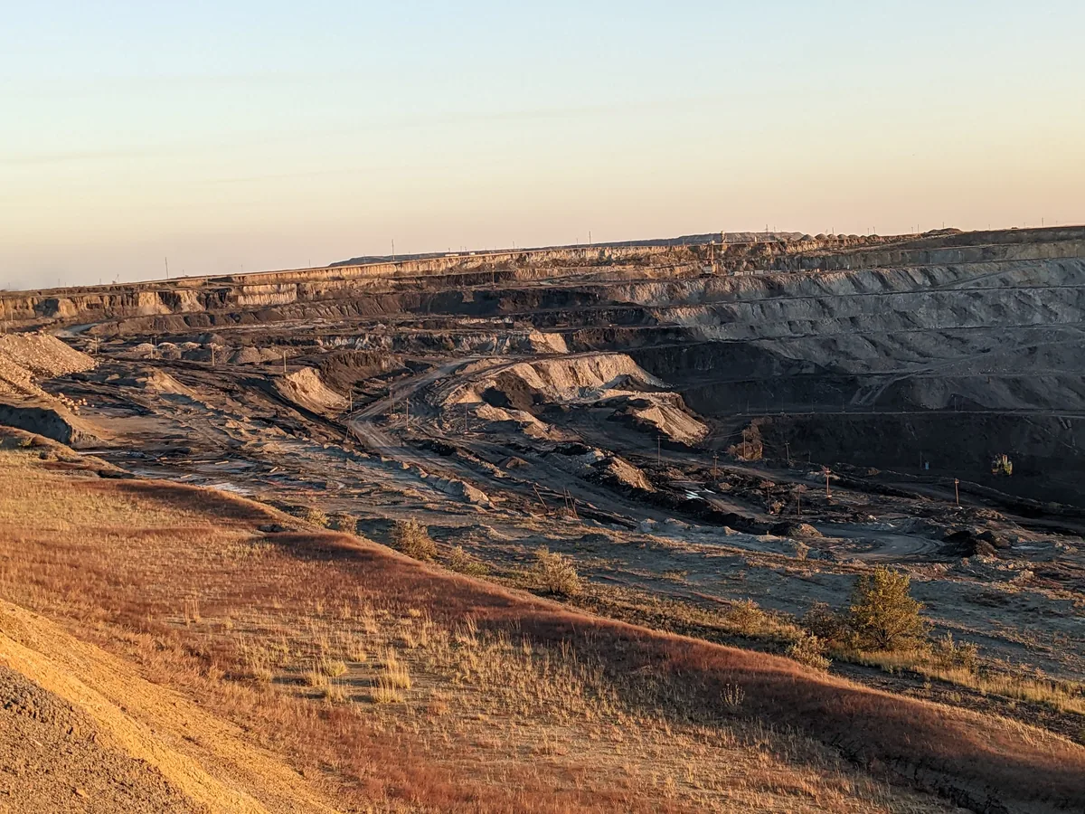 Ekibastuz open pit coal mine at golden hour — vast industrial landscape, Kazakhstan