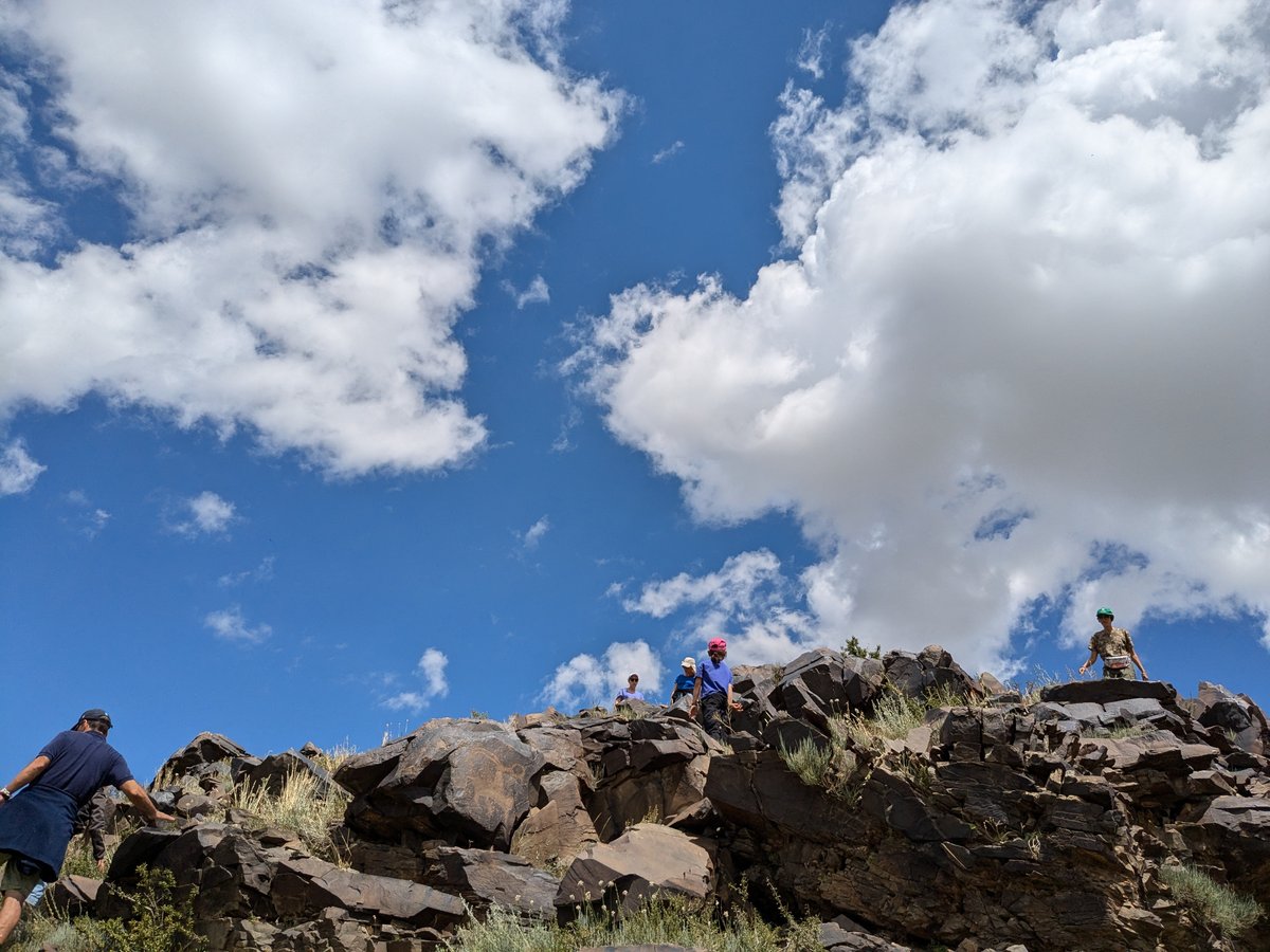 Group exploring petroglyphs gorge with thousands of ancient carvings at Bayan-Zhurek