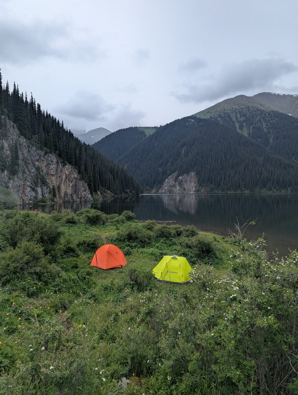 Tents pitched at the Middle Kolsai overnight camping spot beside the lake